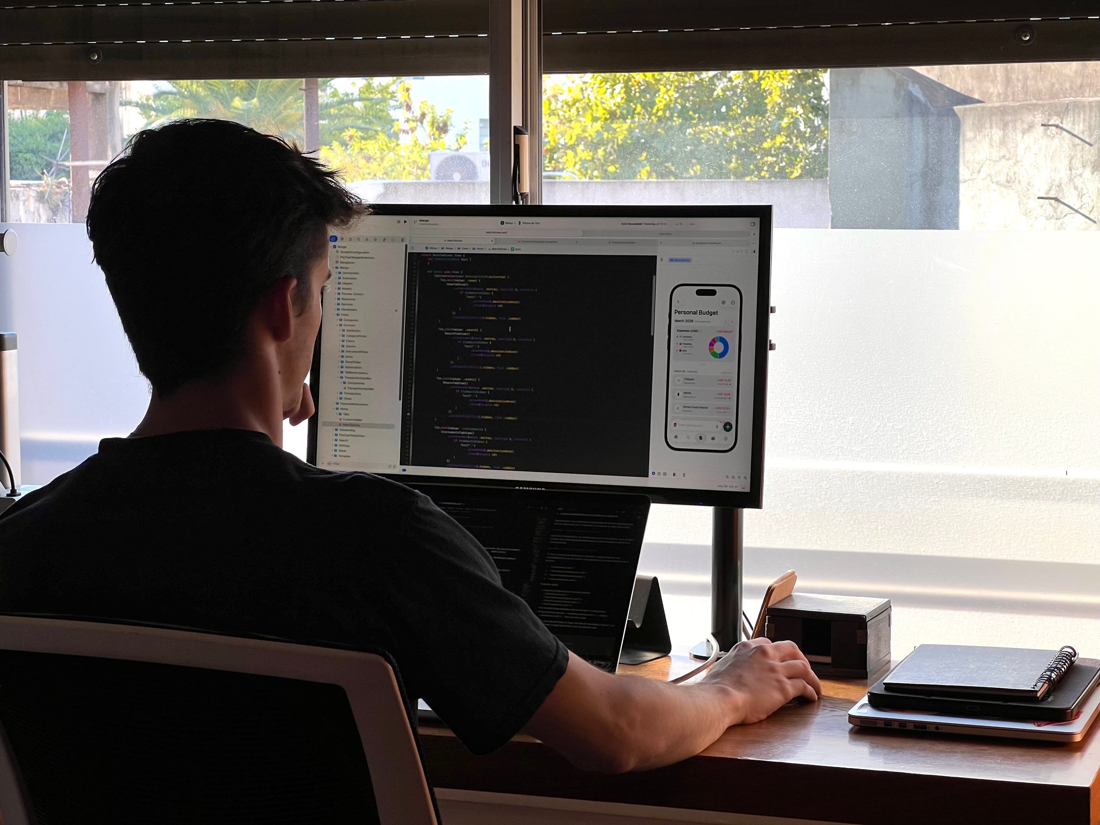 Tomás developing an iOS finance app at his desk